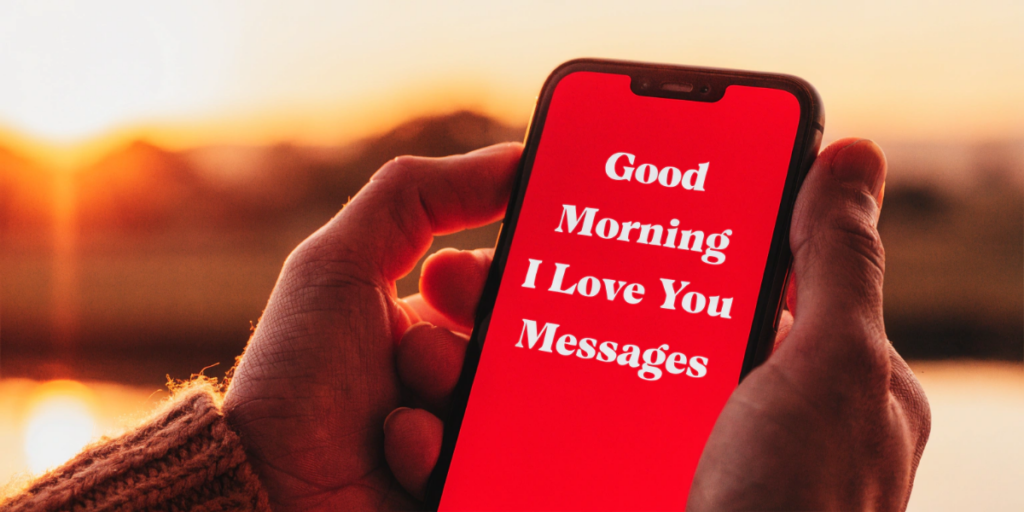 Hands holding a smartphone displaying a loving morning message against a sunrise background with warm golden light and emotional atmosphere